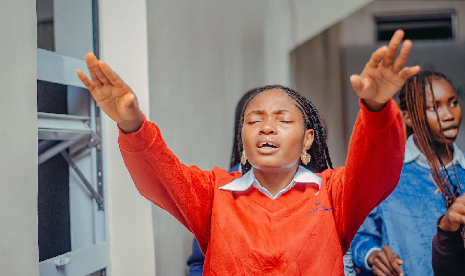 Worshippers with hands raised at a gospel gathering during the August 2026 outreach