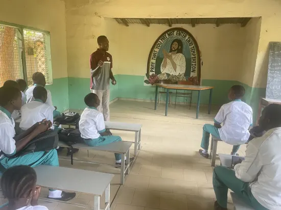 Speaker leading a prayer session with secondary school students, The Gambia, 2022