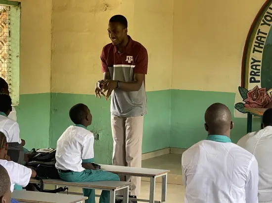 Speaker leading a prayer session with secondary school students, The Gambia, 2022
