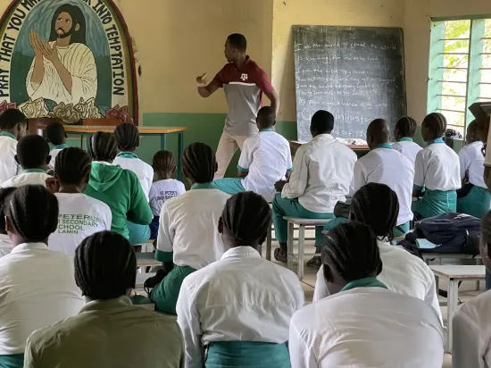 Speaker leading a prayer session with secondary school students, The Gambia, 2022