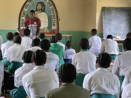 Speaker leading a prayer session with secondary school students, The Gambia, 2022