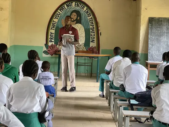 Speaker leading a prayer session with secondary school students, The Gambia, 2022