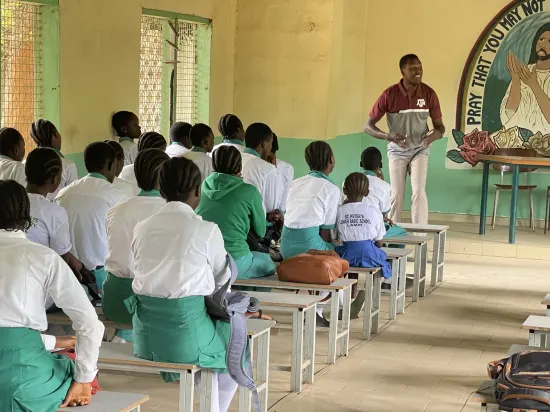 Speaker leading a prayer session with secondary school students, The Gambia, 2022