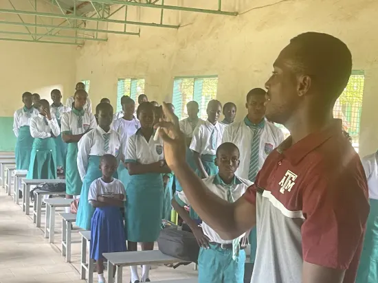 Speaker leading a prayer session with secondary school students, The Gambia, 2022