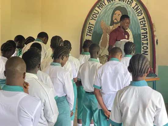 Speaker leading a prayer session with secondary school students, The Gambia, 2022