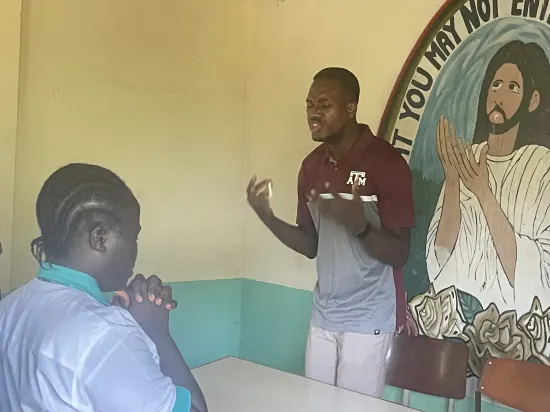 Speaker leading a prayer session with secondary school students, The Gambia, 2022