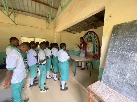 Speaker leading a prayer session with secondary school students, The Gambia, 2022