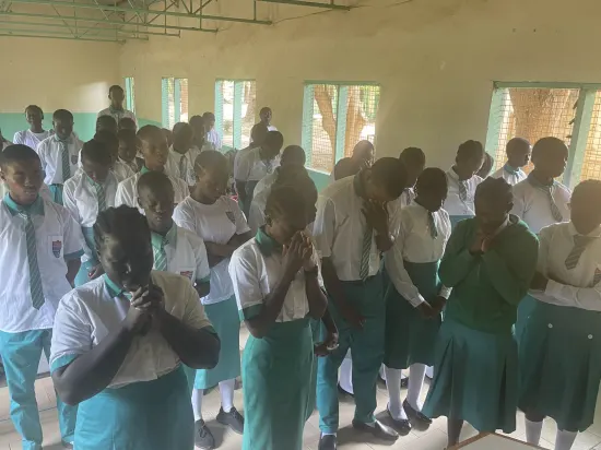 Speaker leading a prayer session with secondary school students, The Gambia, 2022