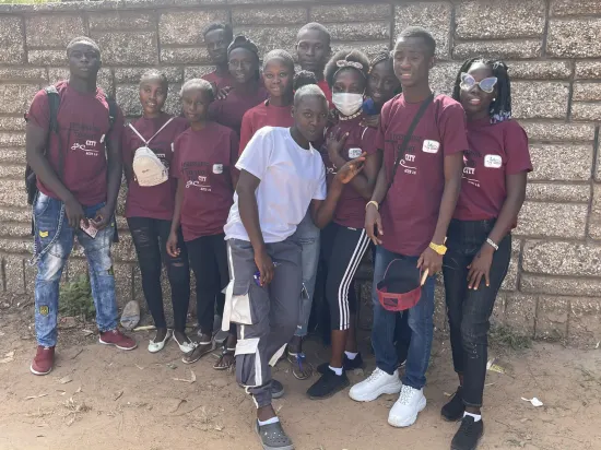 Young people marching together in a street outreach, The Gambia, 2022