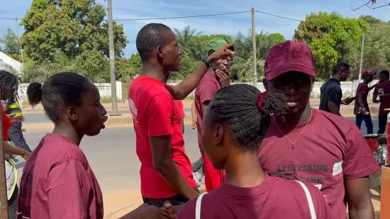 Young people marching together in a street outreach, The Gambia, 2022
