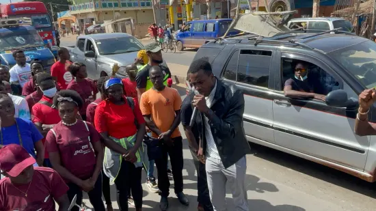 Young people marching together in a street outreach, The Gambia, 2022