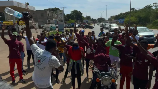 Young people marching together in a street outreach, The Gambia, 2022