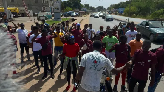 Young people marching together in a street outreach, The Gambia, 2022
