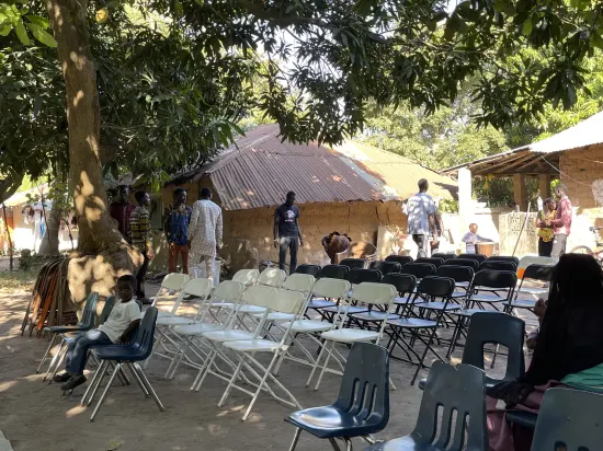 Outdoor community church service under the trees, The Gambia, 2022