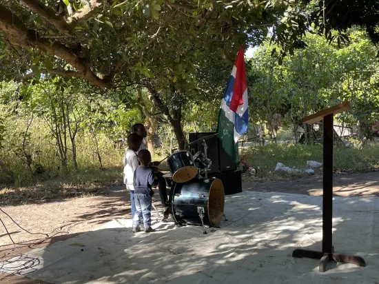 Outdoor community church service under the trees, The Gambia, 2022