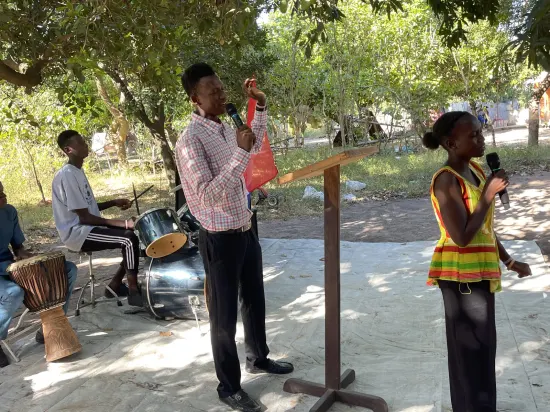 Outdoor community church service under the trees, The Gambia, 2022