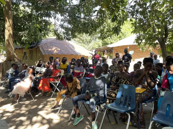 Outdoor community church service under the trees, The Gambia, 2022