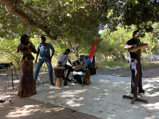 Outdoor community church service under the trees, The Gambia, 2022
