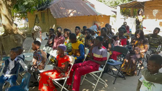 Outdoor community church service under the trees, The Gambia, 2022
