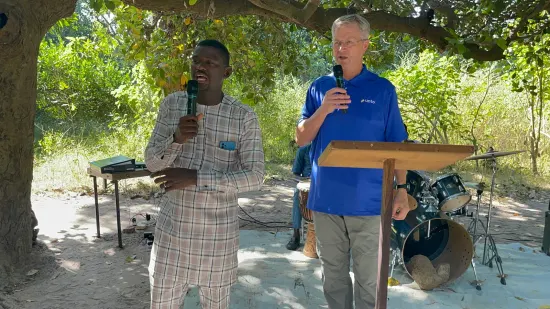 Outdoor community church service under the trees, The Gambia, 2022