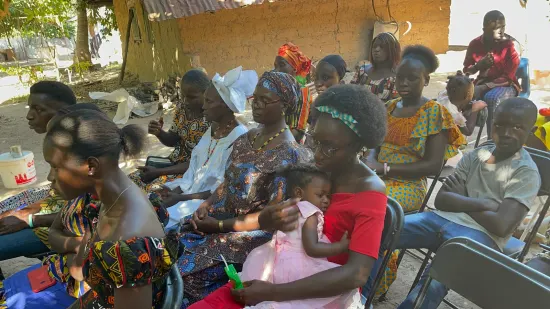 Outdoor community church service under the trees, The Gambia, 2022