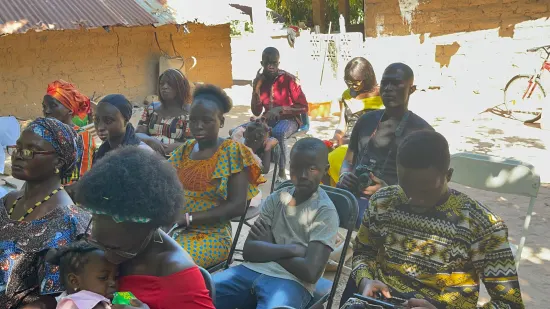 Outdoor community church service under the trees, The Gambia, 2022