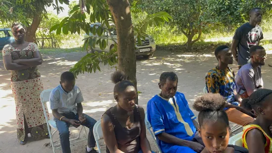 Outdoor community church service under the trees, The Gambia, 2022