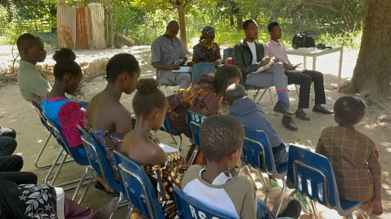 Outdoor community church service under the trees, The Gambia, 2022