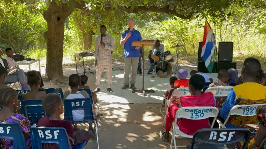 Outdoor community church service under the trees, The Gambia, 2022