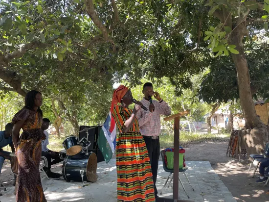 Outdoor community church service under the trees, The Gambia, 2022