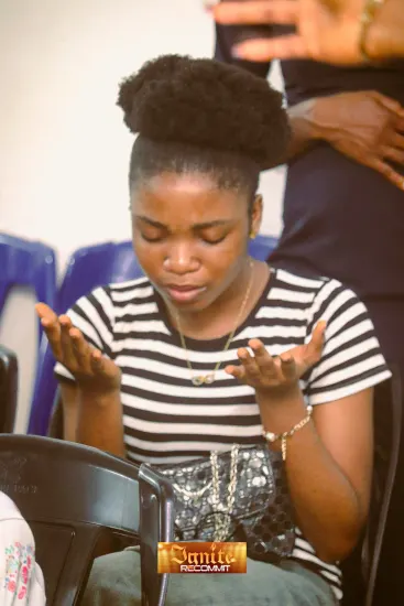 A young woman praying, Ignite 2026